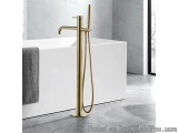 The image shows a modern bathroom with a white bathtub and a gold-colored faucet. The bathtub is rectangular in shape and has...