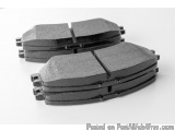 The image shows a pair of brake pads. They are made of metal and have a black finish. The pads are circular in shape and appe...