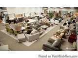 The image shows a large room filled with various furniture and accessories. The room appears to be a furniture store, as ther...