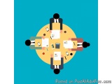 The image shows a group of six people sitting around a round table with papers, pencils, a calculator, and a tablet. The tabl...