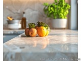 The image shows a kitchen countertop with a marble countertop. On the countertop, there are three oranges and two apples with...