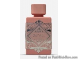 The image is of a perfume bottle with a pink cap. The bottle is rectangular in shape and has a label on it. The label has an...