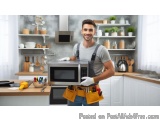 In this image, we can see a young man standing in a kitchen. He is wearing a grey t-shirt, blue jeans, and a yellow tool belt...