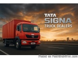 The image shows a red Tata Signa truck on a highway at sunset. The truck is a large, modern vehicle with a flatbed trailer at...