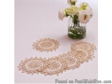 The image shows a table setting with a vase of white flowers on the right side and two doilies on the left side. The doilies...