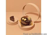 The image shows a chocolate cake with a slice of chocolate cake on the left side. The cake is placed on a white circular plat...