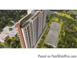 The image is an aerial view of a tall, modern apartment building with multiple floors and balconies. The building is surround...