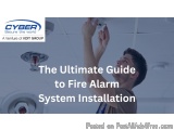 The image shows a man installing a fire alarm system on a ceiling. He is holding the alarm in his right hand and is looking u...