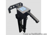 The image shows a black-colored electronic device, which appears to be a machine used for measuring and marking materials. It...