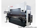 The image shows a large industrial machine, specifically a CNC (Computer Numerical Control) machine. It is a large, rectangul...