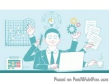 The image shows a man sitting at a desk with a laptop in front of him. He is wearing a suit and tie and has a big smile on hi...