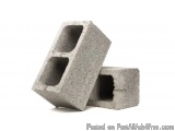 The image shows two concrete blocks stacked on top of each other. The blocks are made of a light grey material and appear to...