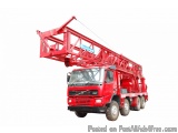 The image shows a red truck with a large crane attached to the back. The crane is a type of aerial work platform used for lif...