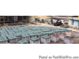 The image shows a large number of stacks of green plastic containers arranged in a neat and orderly manner. The containers ap...