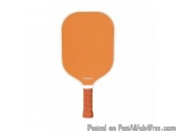 The image is of a ping pong paddle. The paddle is orange in color and has a round shape with a handle on one end. The handle...