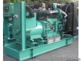 The image shows a large industrial machine, which appears to be a compressor or air compressor. It is green in color and has...