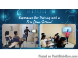 The image shows a classroom with a group of students sitting at desks and a teacher standing in front of a whiteboard. The te...