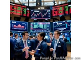 The image shows a group of traders in a trading floor of a stock market. They are all wearing blue suits and are standing in...
