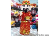 The image shows a large statue of a Chinese deity, wearing a red robe and a gold crown. The deity has a black mustache and is...
