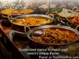 The image shows a variety of Indian dishes displayed on a buffet table. There are several large metal bowls filled with diffe...