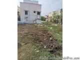 The image shows a small, single-story building with a pink roof and white walls. The building appears to be a single-storey s...
