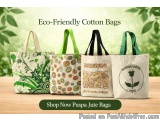 The image shows three eco-friendly cotton bags with green handles. The bags are made of a light-colored fabric and have a uni...