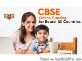 The image shows a mother and son sitting at a desk with a laptop in front of them. The mother is smiling and the son is looki...