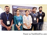 The image shows a group of five people standing in front of a banner that reads "SAP Moving from SAP ECG to S/4 HANA". The ba...
