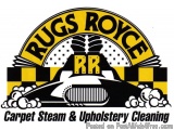The image is a logo for Rugs Royce Carpet Steam & Upholstery Cleaning. The logo is circular in shape and has a yellow backgro...