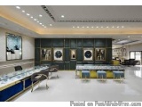 The image shows a modern and luxurious interior of a jewelry store. The store has a high ceiling with recessed lighting and l...