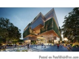 The image is a 3D rendering of a modern building with a unique architectural design. The building is located in a park-like s...