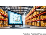 The image shows a desktop computer monitor in a warehouse. The monitor is displaying a dashboard with various graphs and char...