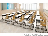 The image shows a large classroom with rows of desks and chairs arranged in neat rows. The desks are white with black legs an...