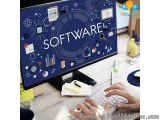 The image shows a person's hands typing on a computer keyboard in front of a desktop computer monitor. The monitor screen dis...