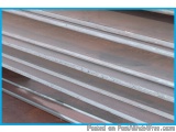 The image shows a close-up of a stack of metal sheets. The sheets are arranged in a horizontal line, with each sheet slightly...