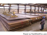 The image shows a large warehouse with a high ceiling and large windows. In the center of the image, there is a large pile of...