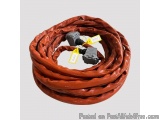 The image shows a red-colored cable with two black connectors attached to it. The cable appears to be coiled up and is lying...