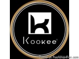 The image is a logo for a company called "Kookee". The logo is circular in shape and has a black background with a gold borde...