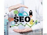 The image shows a person's hands holding a white t-shirt with the word "SEO" written in black capital letters. Surrounding th...