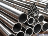 The image shows a stack of stainless steel pipes. The pipes are arranged in a neat and orderly manner, with each pipe slightl...