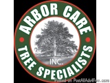 The image is a circular logo for Arbor Care Tree Specialists, Inc. The logo is circular in shape and has a green background w...