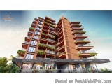 The image is a 3D rendering of a modern apartment building. The building is tall and has multiple floors, with balconies on e...