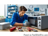 In this image, we can see a young man working in a kitchen. He is wearing a blue uniform and gloves and is sitting at a woode...