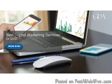 The image shows a desk with a laptop, a calculator, a pen, and a mobile phone on it. The laptop screen displays a graph with...