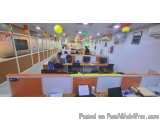 The image shows an office space with multiple cubicles arranged in a neat and orderly manner. The cubicles are orange and whi...