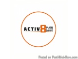 The image is a logo for ACTIV8 Pilates & Rehab Studio. It is a circular orange circle with the word "ACTIV8" written in black...