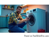 In this image, we can see a young man in a laundry room, kneeling on the floor and fixing a washing machine. He is wearing a...