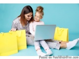 The image shows a mother and daughter sitting on the floor with yellow shopping bags around them. The mother is sitting on he...