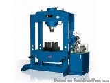 The image shows a blue-colored hydraulic press machine. It is a large, industrial-looking machine with a rectangular base and...