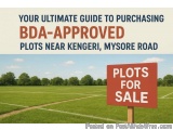 The image shows a large open field with a red sign that reads "Plots for Sale" in white letters. The field is surrounded by t...